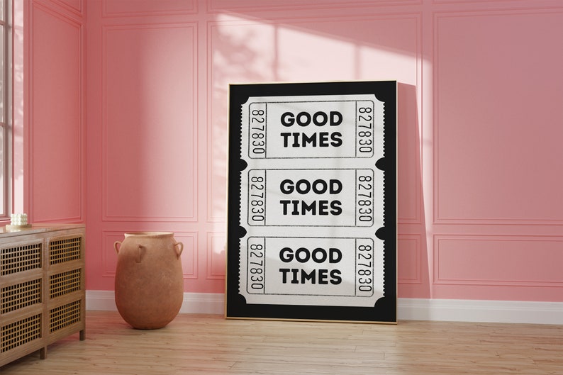 May include: Black and white print of three vintage ticket stubs with the text "GOOD TIMES" repeated on each ticket. The print is framed and hanging on a pink wall.