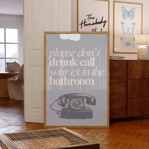 May include: A gray poster with a black rotary phone and the text "please don't drunk call your ex in the bathroom".
