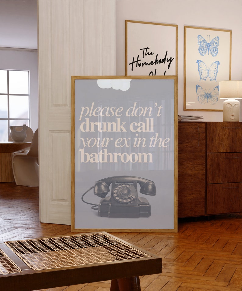 May include: A gray poster with a black rotary phone and the text "please don't drunk call your ex in the bathroom".