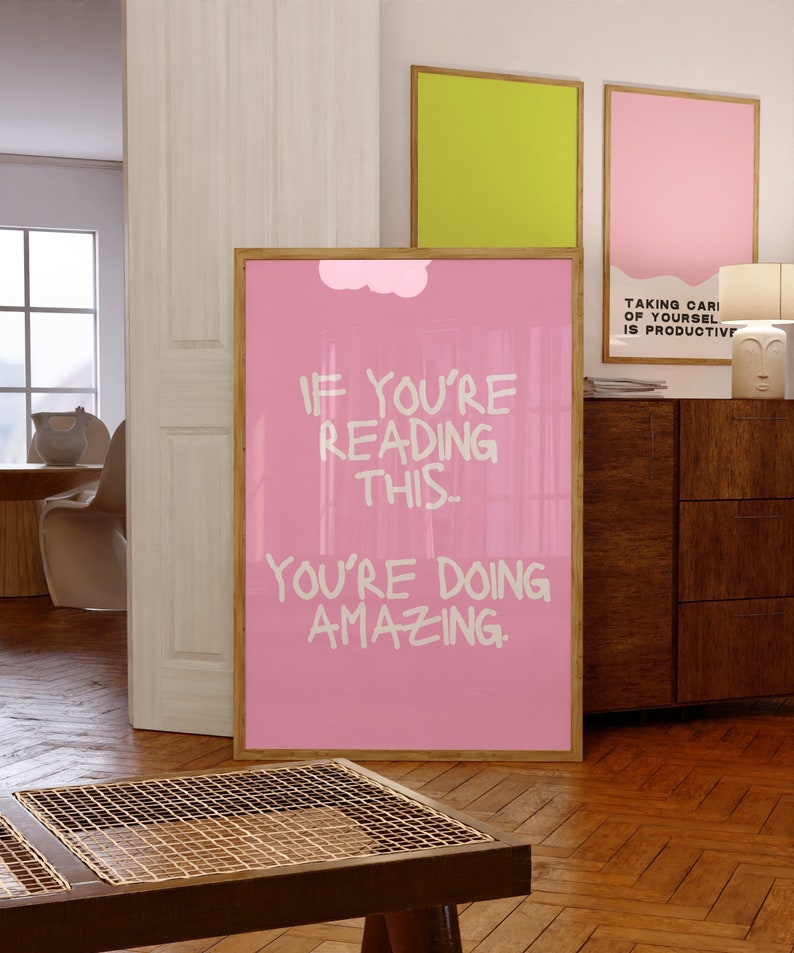 May include: Pink motivational poster with a white cloud and the text "If you're reading this... you're doing amazing."