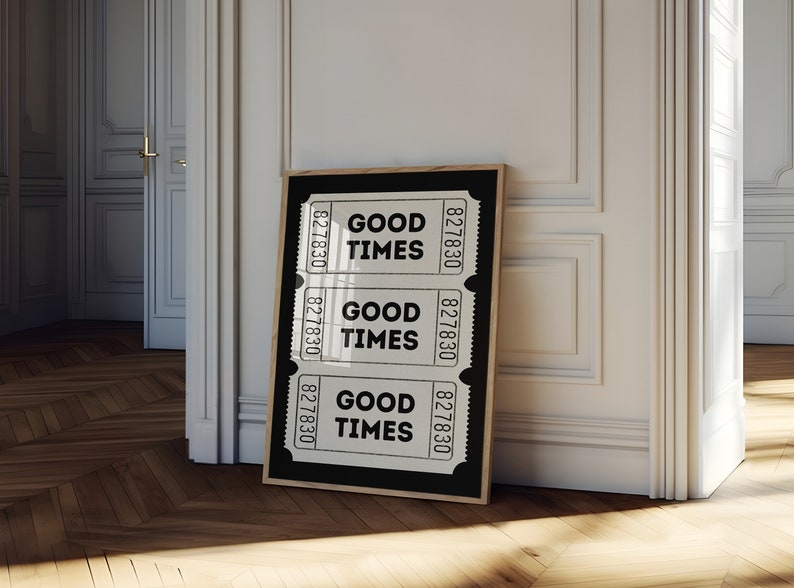 May include: A black framed poster with three white ticket-shaped designs. Each ticket has the text "GOOD TIMES" and the number "827830" printed on it.