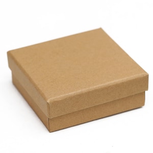 May include: A small, square, brown cardboard box with a lid. The box is made of corrugated cardboard and has a simple, clean design. The box is likely used for packaging small items.