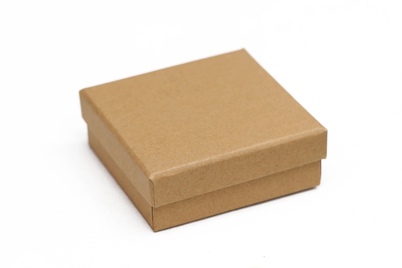 May include: A small, square, brown cardboard box with a lid. The box is made of corrugated cardboard and has a simple, clean design. The box is likely used for packaging small items.