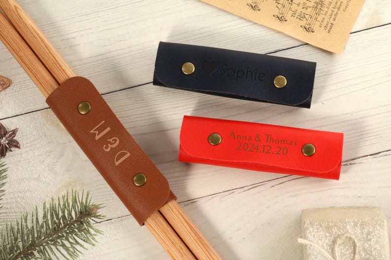 May include: Three leather cases for chopsticks, one brown with the name "D&M" engraved, one red with the text "Anna & Thomas 2024.12.20" engraved, and one blue with the name "Sophie" engraved.