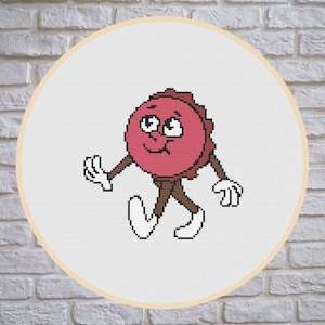 May include: A cross-stitch pattern of a cartoon bottle cap with a face and arms, walking. The bottle cap is red and brown, and the background is white.