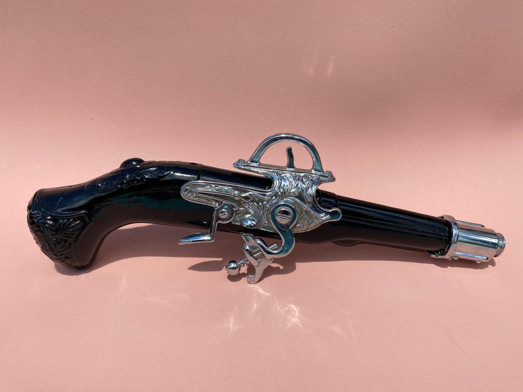 cologne bottle that looks like a revolver