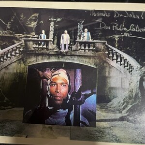 May include: A black and white photo of a man with a bandage on his head. The man is looking at the camera. The photo is set against a backdrop of a stone bridge with a staircase leading up to it. The photo is signed "Thanks Dr. John! Don Pedro Collery".