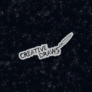 May include: A black and white illustration of a paintbrush with the words "Creative Draws Design" on a black background with white speckles.