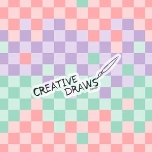 May include: A checkered background with alternating pink and light green squares. The text "CREATIVE DRAWS Design" is written in a white oval with a black outline. A black and white drawing of a paintbrush is above the text.