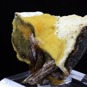 May include: A cluster of brown, needle-like crystals with a yellow, crystalline matrix. The crystals are sharp and pointed, and the matrix is rough and textured.