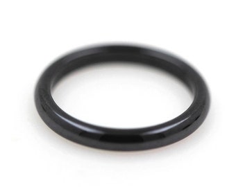 May include: A simple black ring with a smooth, polished finish.