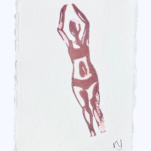 May include: A brown ink drawing of a person in a swimsuit with their arms raised above their head. The drawing is on a white paper background.