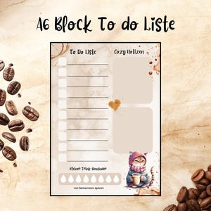 Könnte beinhalten: A6 Block To Do List Notizblock mit Aquarelldesign. Der Notizblock hat eine To-Do-Liste, einen gemütlichen Bereich und eine niedliche Katzenillustration. Kaffeebohnen sind um den Notizblock verstreut.