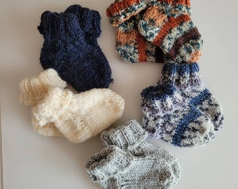 Baby socks hand knitted with Regia socks wool available in multiple sizes and colors.