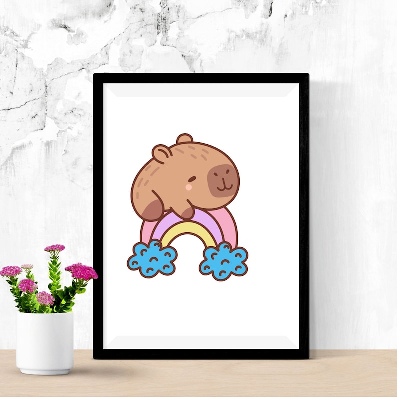 May include: A brown capybara with a pink nose and big eyes sits on top of a rainbow with blue clouds. The rainbow is pink, purple, yellow, and white.