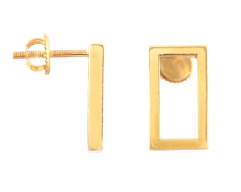 May include: A pair of gold-tone earrings. One earring is a simple bar, the other is a square frame.