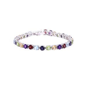 May include: A silver bracelet featuring a row of colourful gemstones. The gemstones are set in a silver band and arranged in a rainbow pattern.
