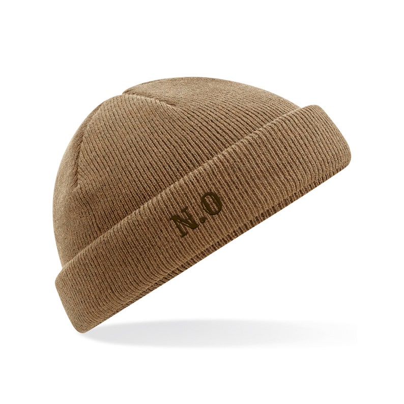May include: A brown knitted beanie with a fold-over cuff and the letters "N.O." embroidered on the front.