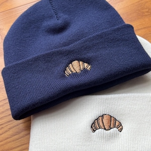 Cosy Turn-Up Beanie with Embroidered Croissant Design - Available in Caramel or Navy Blue