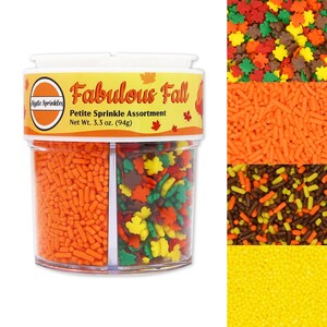May include: A clear plastic container with three compartments filled with colourful sprinkles. The container is labelled "Fabulous Fall Petite Sprinkle Assortment Net Wt. 3.3 oz. (94g)". The sprinkles are in the colours of autumn: orange, brown, yellow, and green.