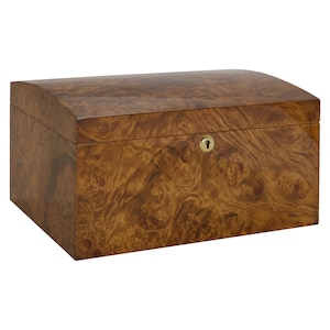 May include: A wooden box with a curved lid and a brass lock. The box is made of a light brown wood with a dark brown grain pattern.