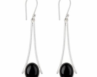 May include: A pair of silver-toned dangle earrings. Each earring features a teardrop-shaped design with a polished black oval stone at the base. The earrings have a simple, elegant design, suitable for everyday wear or special occasions.