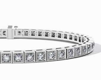 May include: A silver tennis bracelet with square-shaped diamonds set in a row.