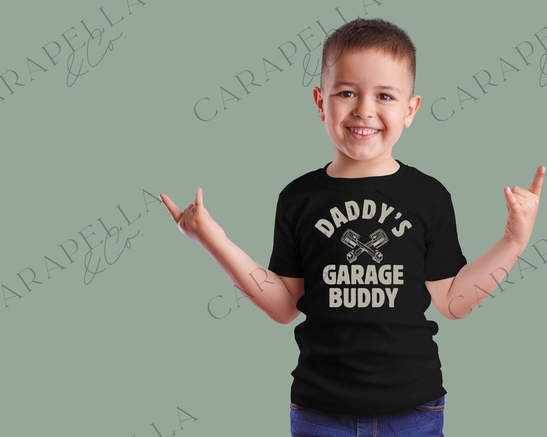 May include: Black t-shirt with a white graphic that says "Daddy's Garage Buddy" with a pair of crossed wrenches.