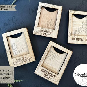 May include: Four wooden photo frames with different engraved messages. The frames are made of light brown wood and have a slot for a photo. The messages are "Birthday Girl", "Our Greatest Gift", "Love You To The Moon & Back And Back Again", and "Birthday Boy".