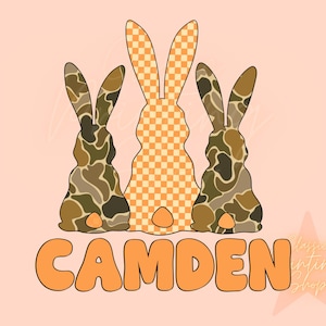 May include: Three bunny silhouettes in a row. The middle bunny is orange and white checkered. The bunnies on either side are camouflage patterned in shades of brown and green. The word "CAMDEN" is written in orange bubble letters below the bunnies.