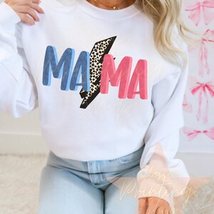 May include: White sweatshirt with the word "MAMA" in blue and pink letters with a leopard print lightning bolt in between the words.