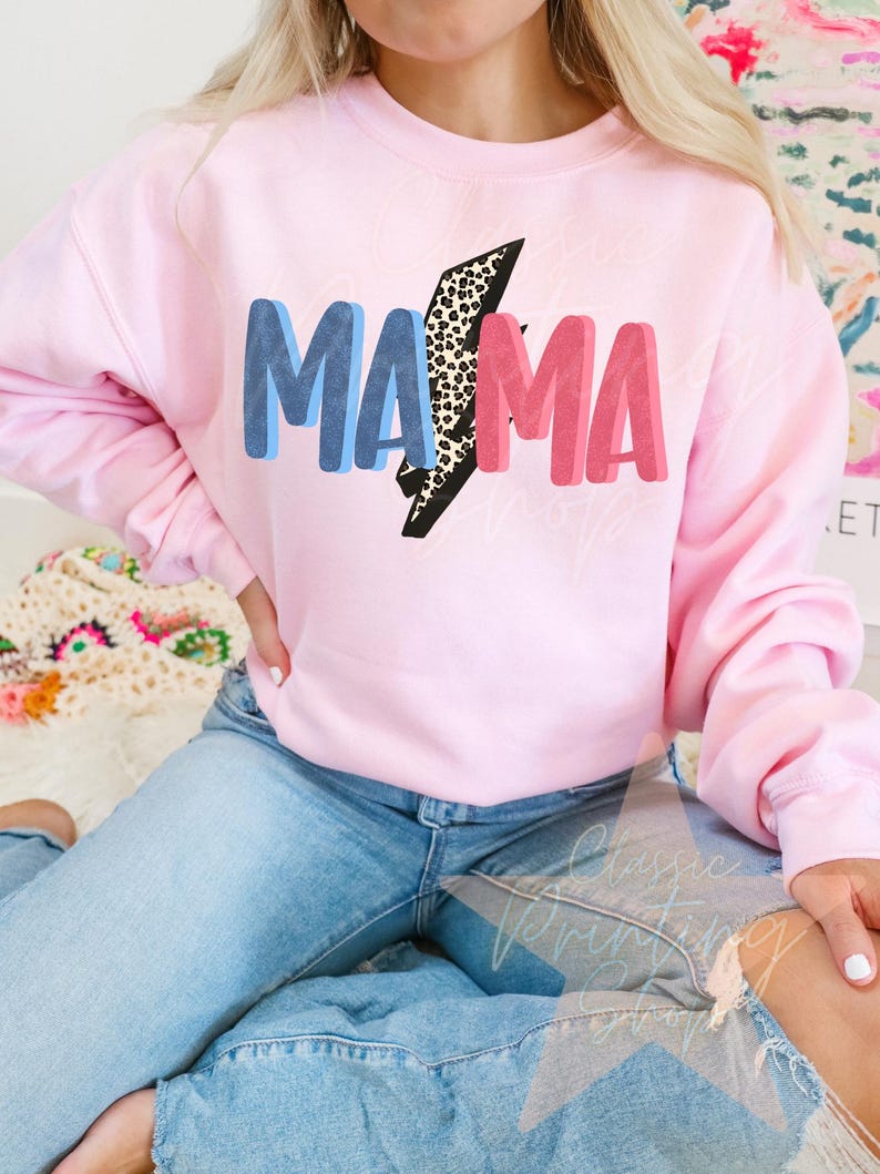 May include: A pink sweatshirt with the word "MAMA" in blue, pink, and black letters with a leopard print lightning bolt design.