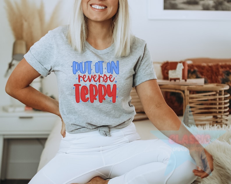 May include: A gray t-shirt with the text "Put it in reverse Terry" in red and blue lettering.