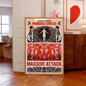 May include: A black and white poster with red accents. The poster features a woman standing in a circle of roses with the text "Heligoland Pictures Paradise Circus" above her and "Massive Attack" below her.