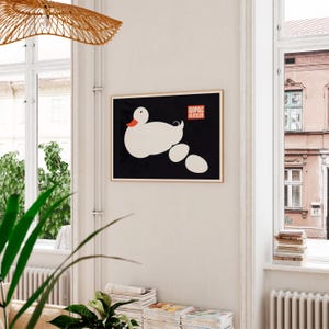 May include: A black and white poster with a white duck and the text "WIPAC KLINCER" in red and white. The duck is laying on a series of white oval shapes.