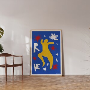 May include: A blue poster with a yellow figure dancing with red and white stars. The poster has the word "REVE" in white letters.