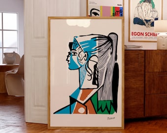 May include: A colorful abstract portrait of a woman with a blue head scarf, blue and orange shirt, and green and black background. The artwork is signed "Picasso" in the bottom right corner.