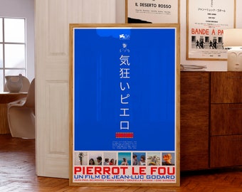 May include: A framed movie poster with a blue background and Japanese text. The poster features the title "Pierrot le Fou" in French and the names of the actors and director. Other framed posters are visible in the background.