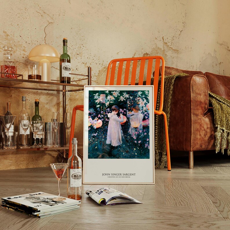 May include: A framed art print featuring John Singer Sargent's painting Carnation, Lily, Lily, Rose, depicting two figures in white dresses lighting lanterns in a garden. The print includes the artist's name and title in black text at the bottom.