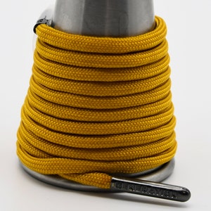 May include: A spool of yellow shoelaces with a black tag that reads "GENERATION".