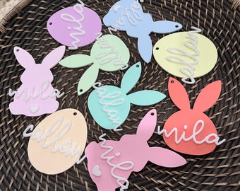 May include: A collection of pastel-colored Easter egg and bunny shapes with the names "Mila" and "Callan" written in white on each.
