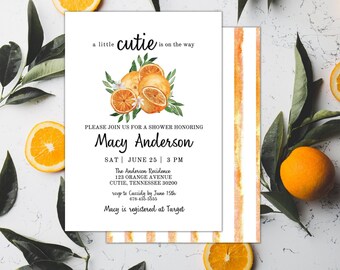 May include: A white invitation with orange watercolor stripes on the right side. The left side features a watercolor illustration of oranges and leaves with the text "a little cutie is on the way". The invitation is for a baby shower honoring Macy Anderson on Saturday, June 25th at 3 PM at The Anderson Residence, 123 Orange Avenue, Cutie, Tennessee 30200. RSVP to Cassidy by June 15th at 678-455-5555. Macy is registered at Target.