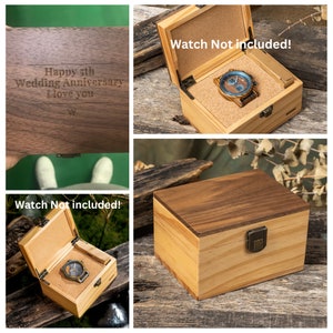 May include: A wooden box with a hinged lid and a brass latch. The box is made of light and dark wood and has a natural wood finish. The lid is engraved with the text "Happy 5th Wedding Anniversary I love you". The box is shown open and empty, with the text "Watch Not included!" printed on the inside of the lid.