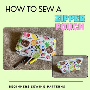 May include: A white zipper pouch with a colorful fruit pattern, including apples, bananas, and kiwi. The text "HOW TO SEW A ZIPPER POUCH" is at the top, with "BEGINNERS SEWING PATTERNS" at the bottom. Several pens are visible.