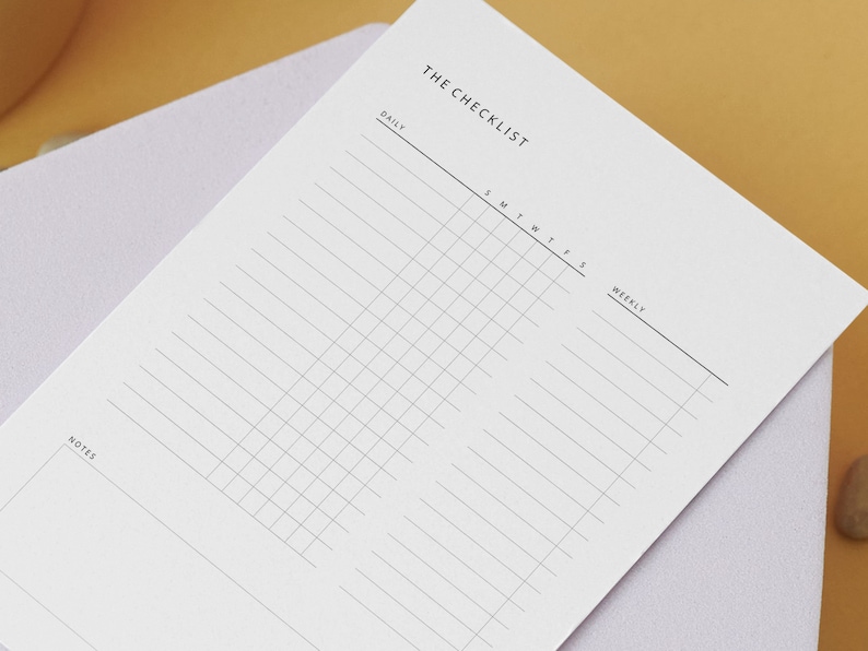 May include: A white checklist with the title "THE CHECKLIST" at the top. The checklist is divided into two sections: "DAILY" and "WEEKLY". The "DAILY" section has a grid with columns for each day of the week, and the "WEEKLY" section has a list of lines for writing tasks.