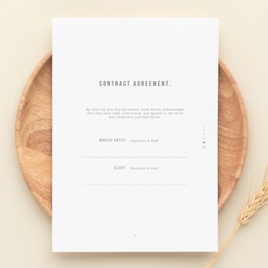 May include: A white contract agreement form with the title "CONTRACT AGREEMENT." The form has two lines for signatures and dates, one for the makeup artist and one for the client.