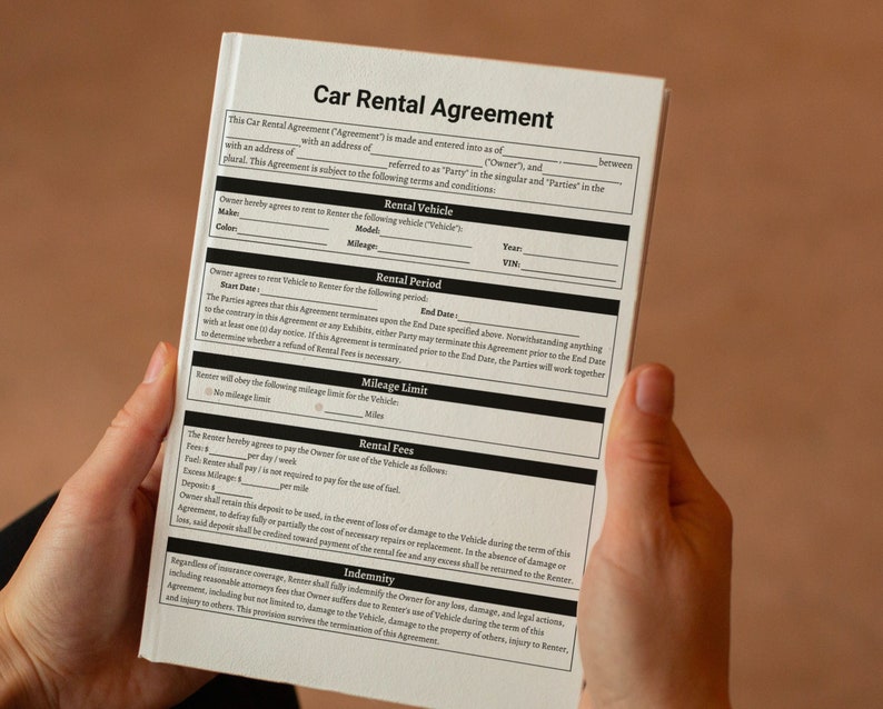 May include: A black and white car rental agreement form with the title "Car Rental Agreement" at the top. The form includes sections for rental vehicle details, rental period, mileage limit, rental fees, and indemnity.