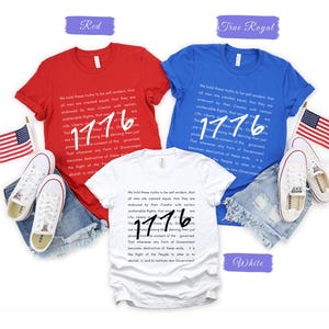 May include: Red, white, and blue t-shirts with the text "1776" and a quote. The shirts are paired with denim shorts and white sneakers. American flags are also included in the image.