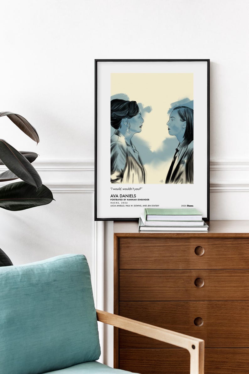 May include: Framed art print featuring a blue-toned illustration of two women facing each other. The artwork includes the text "I would, wouldn't you?" and the name "AVA DANIELS". The print is displayed on a wooden cabinet.
