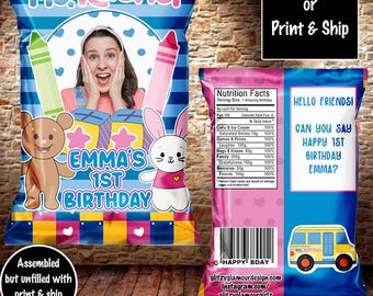 May include: A personalized chip bag design for a first birthday party. The bag features a photo frame, a bunny and bear illustration, and the text "Emma's 1st Birthday". The back of the bag includes a nutrition facts label with a humorous twist, and the text "Hello friends! Can you say Happy 1st Birthday Emma?"